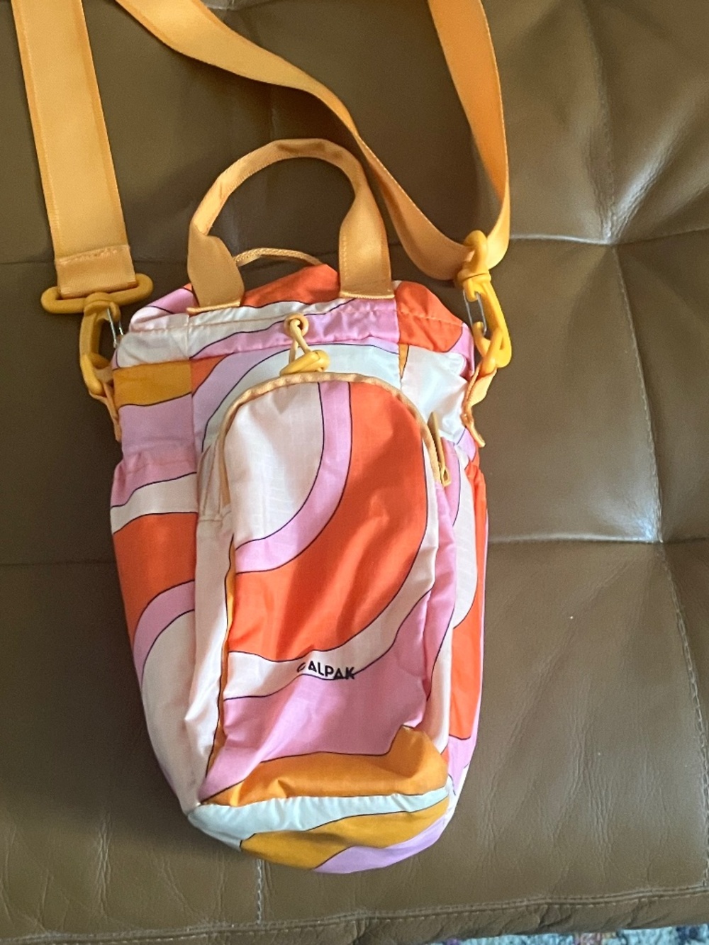 CALPAK water bottle holder cross body sling bag multicolor Orange wavy print